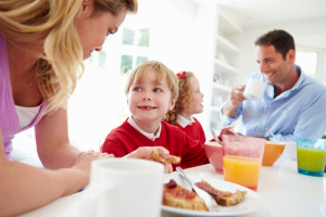 family having breakfast before school