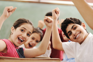 Happy children smiling and laughing in the classroom (1)